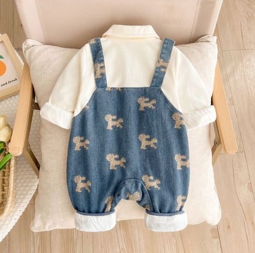 Adorable denim baby romper with embroidered bunny pattern and ruffled white collar details.