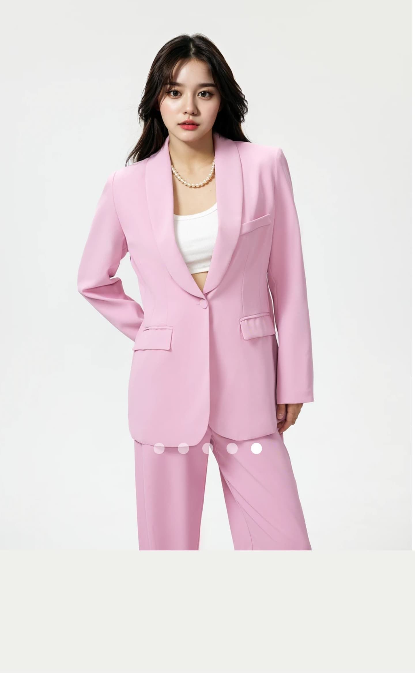 Fashion photography of pink business suit with white undershirt in studio setting.