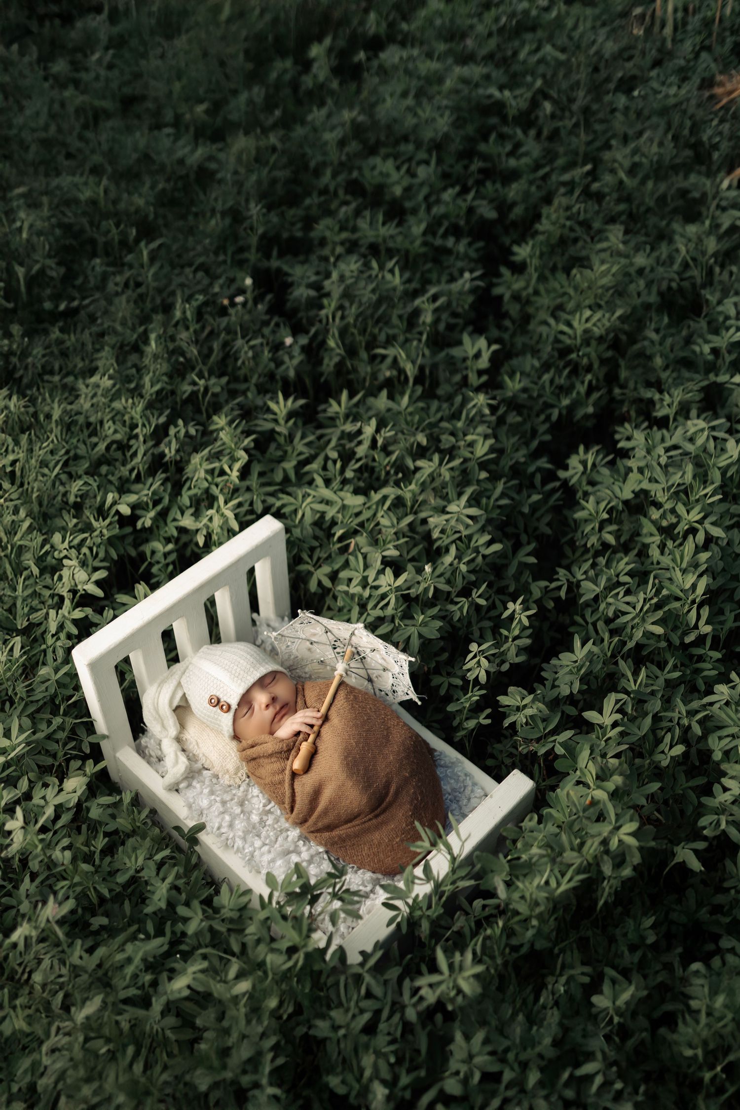 Baby girl wrapped in pink swaddle for new born photoshoot – Impresio Studio