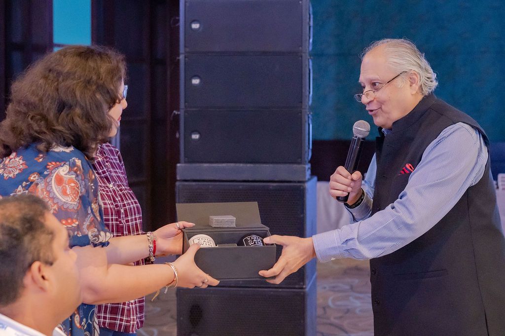 A close-up shot of an award being handed over during a ceremony on stage.