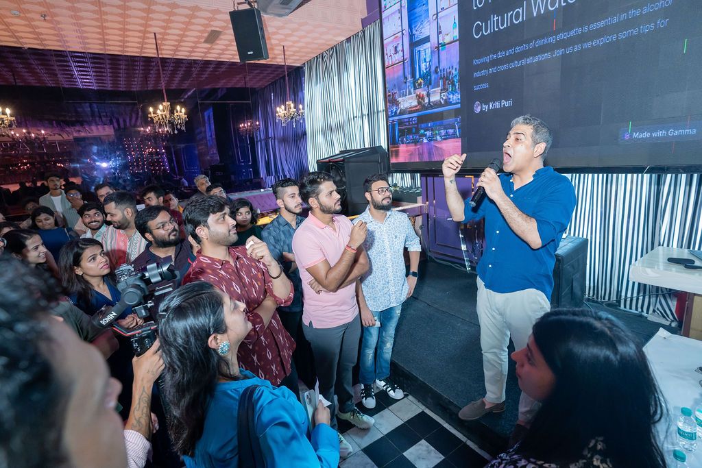 Speaker presenting to engaged audience at a tech cultural workshop event in a modern venue.
