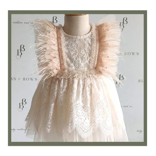 Elegant blush pink lace dress with ruffled tulle details displayed on mannequin.