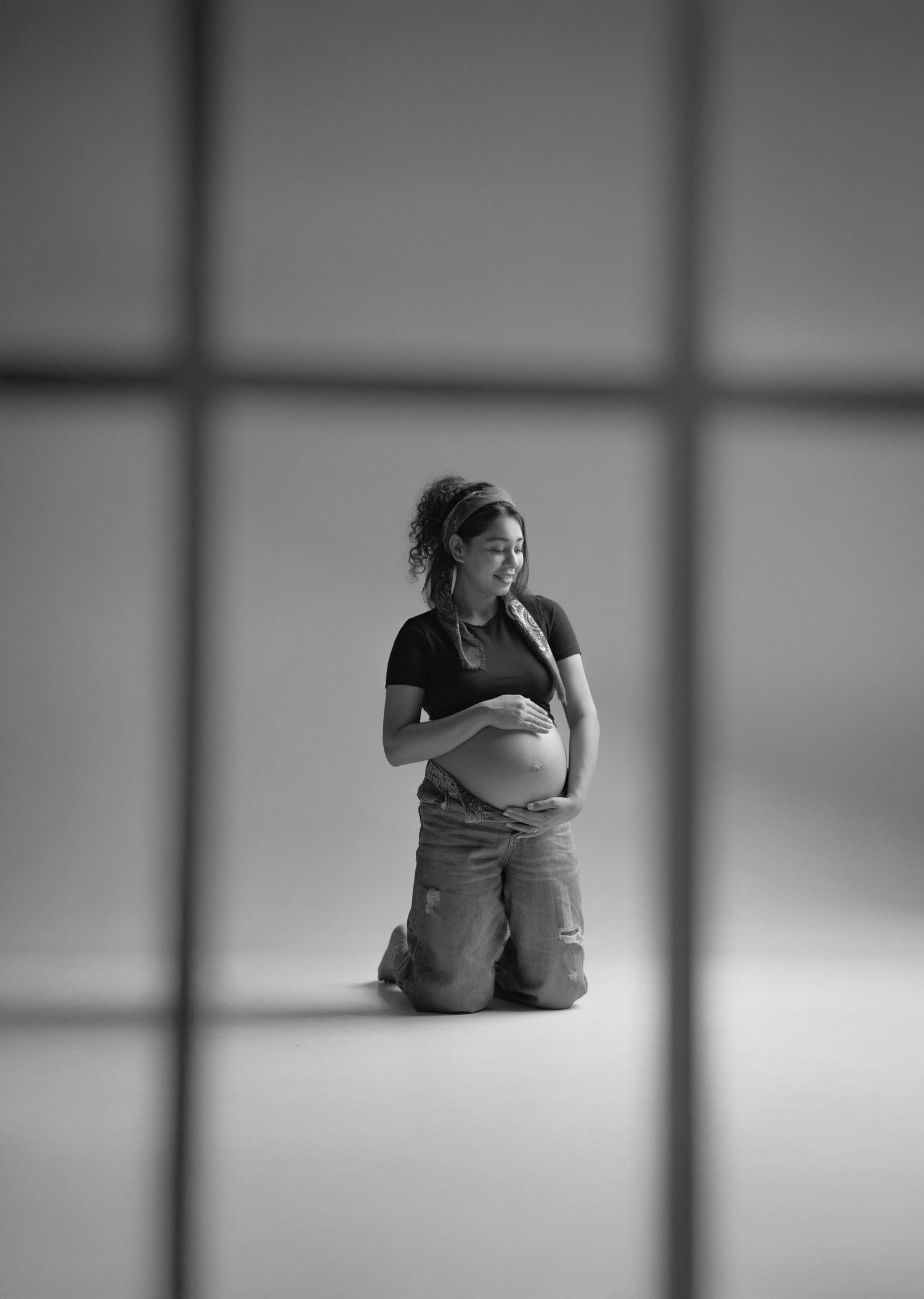 A series of minimalist black and white photographs showing a person in contemplative poses against a stark background.