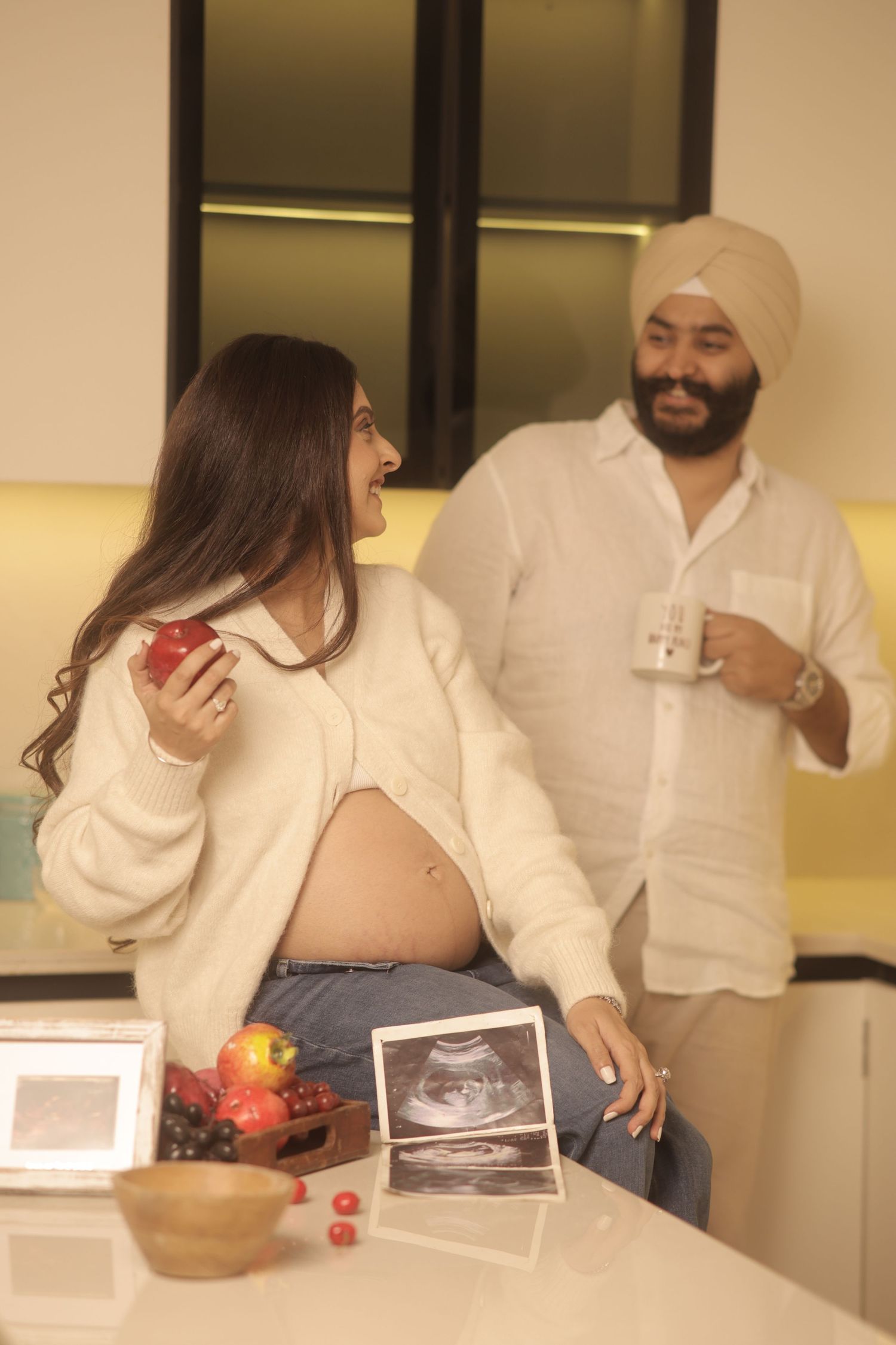 A series of photos showing a couple looking at ultrasound images and sharing an emotional moment in a white room.