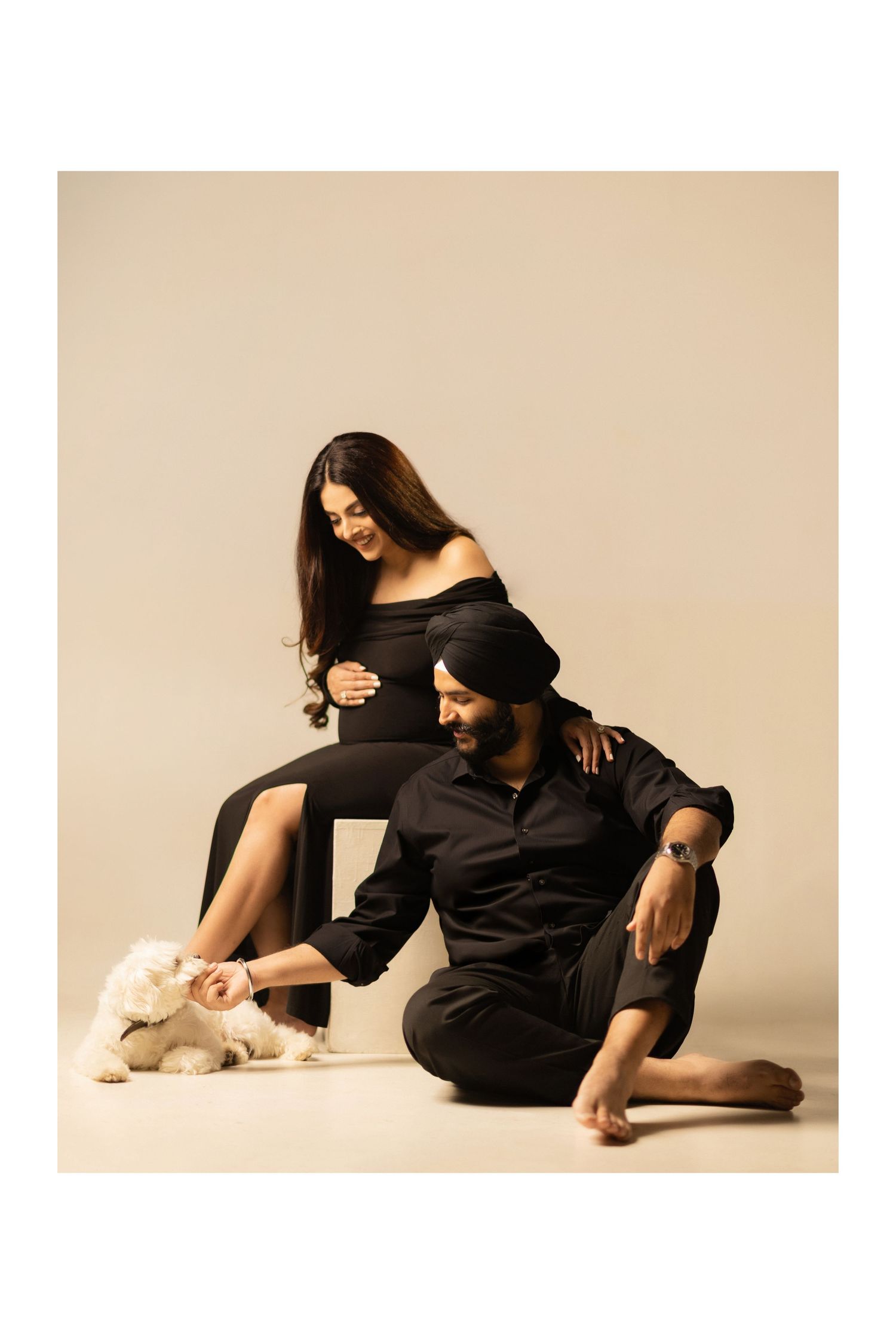 A figure in black attire performs a graceful dance sequence against a beige backdrop in a series of connected poses.