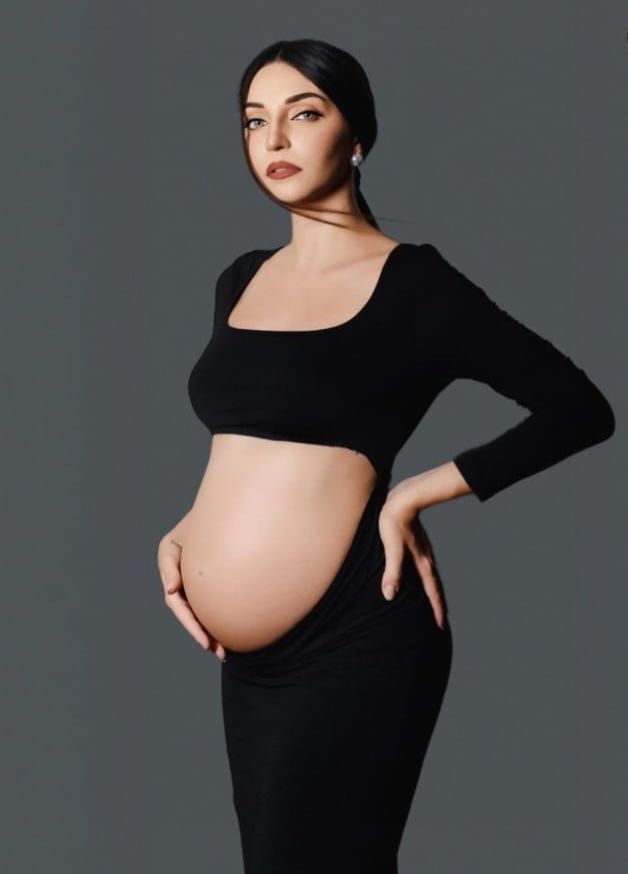 Elegant maternity portraits in black dress showing various artistic poses against gray backdrop.