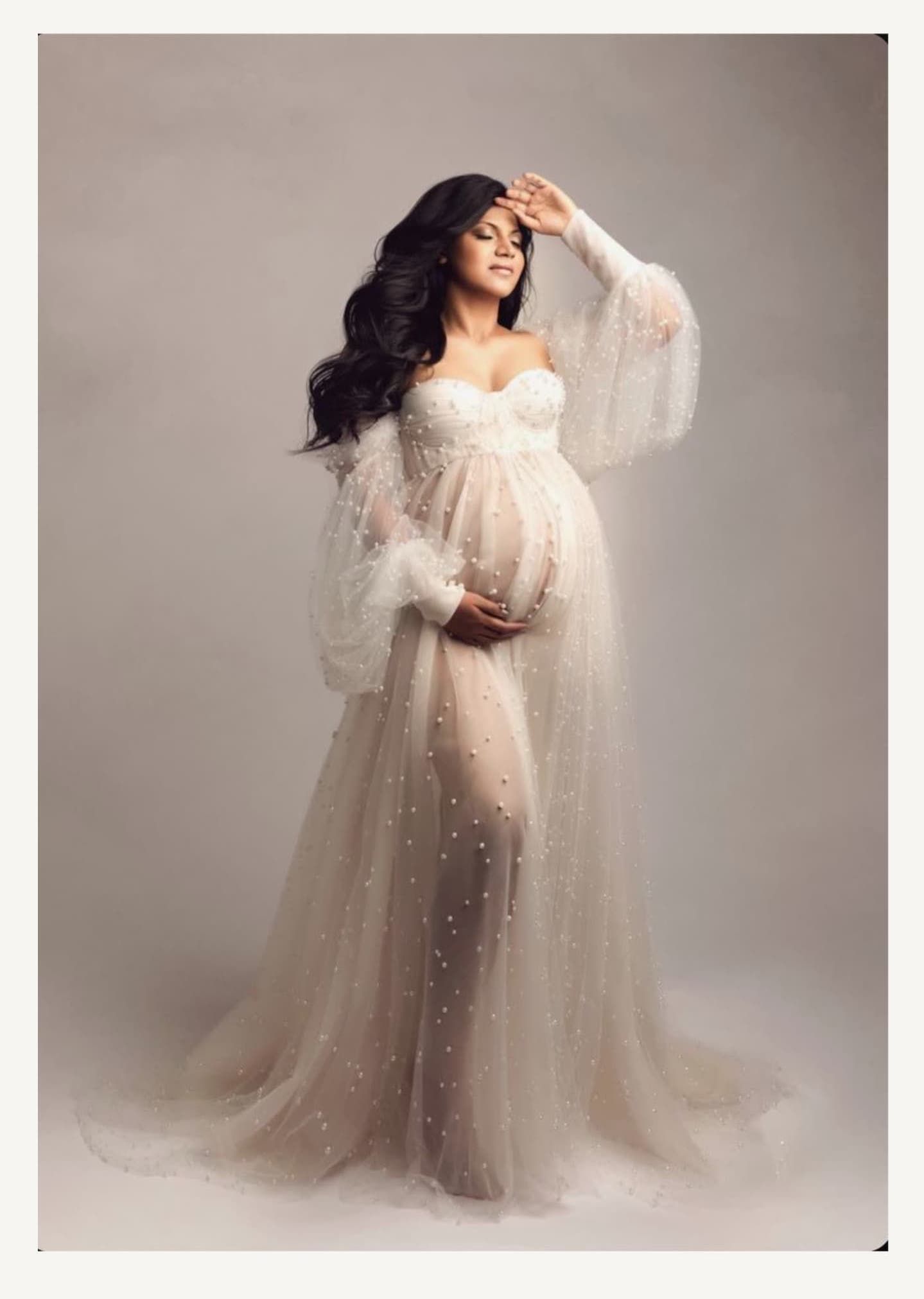 Ethereal studio maternity session featuring sparkly tulle gown against neutral background.
