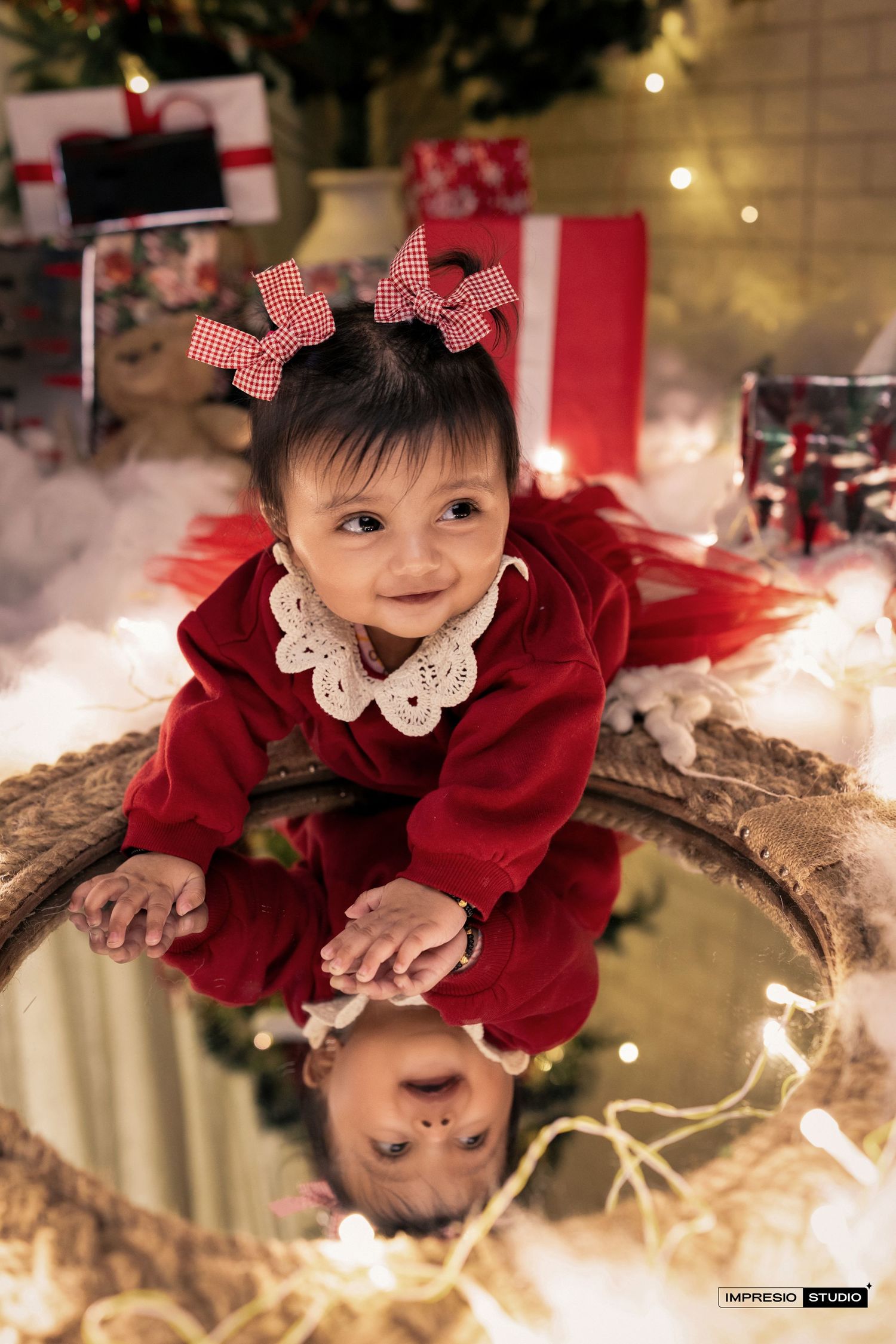 A red velvet holiday photo series with twinkling lights and festive decorations creating a magical Christmas scene.