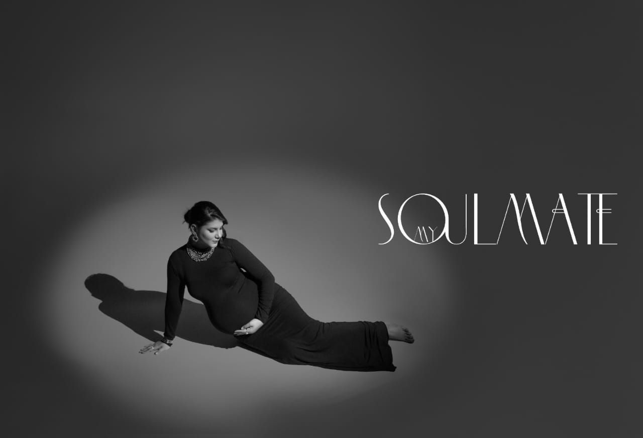 Dramatic black and white maternity silhouette series with minimalist aesthetic.