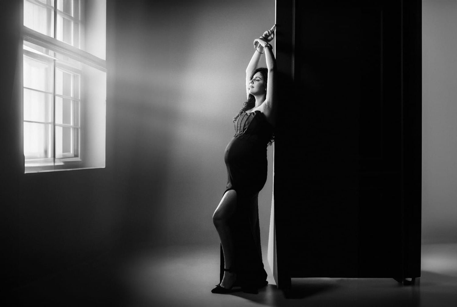 High contrast black and white photos with dramatic window lighting and silhouettes.