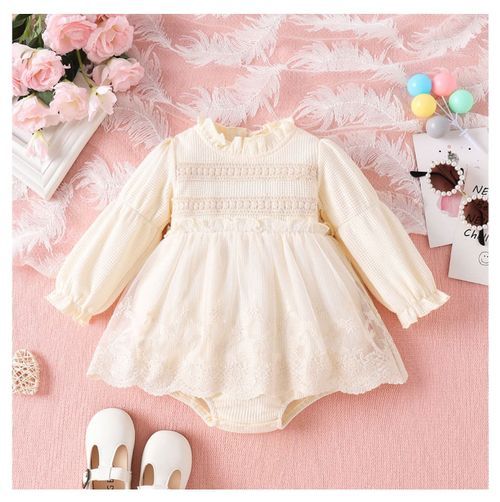 Vintage-style cream lace baby dress with long sleeves and delicate embroidery details.