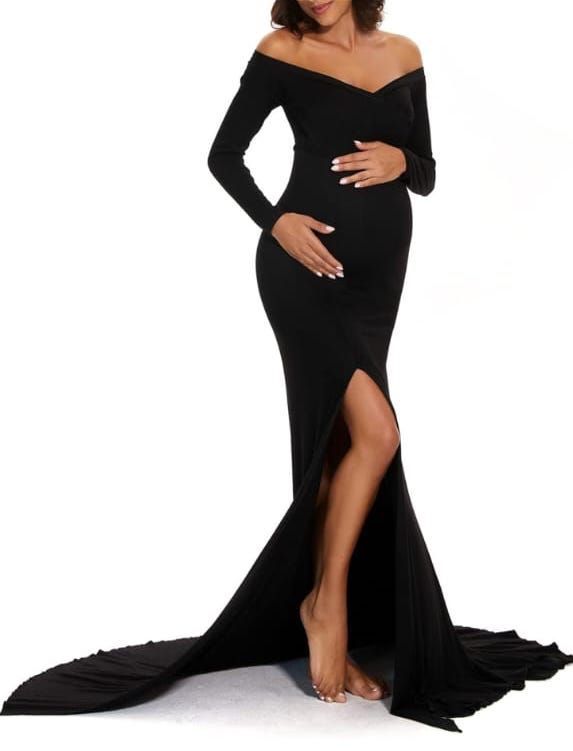 Maternity photoshoot featuring an elegant black off-shoulder gown with a dramatic side slit on white background.