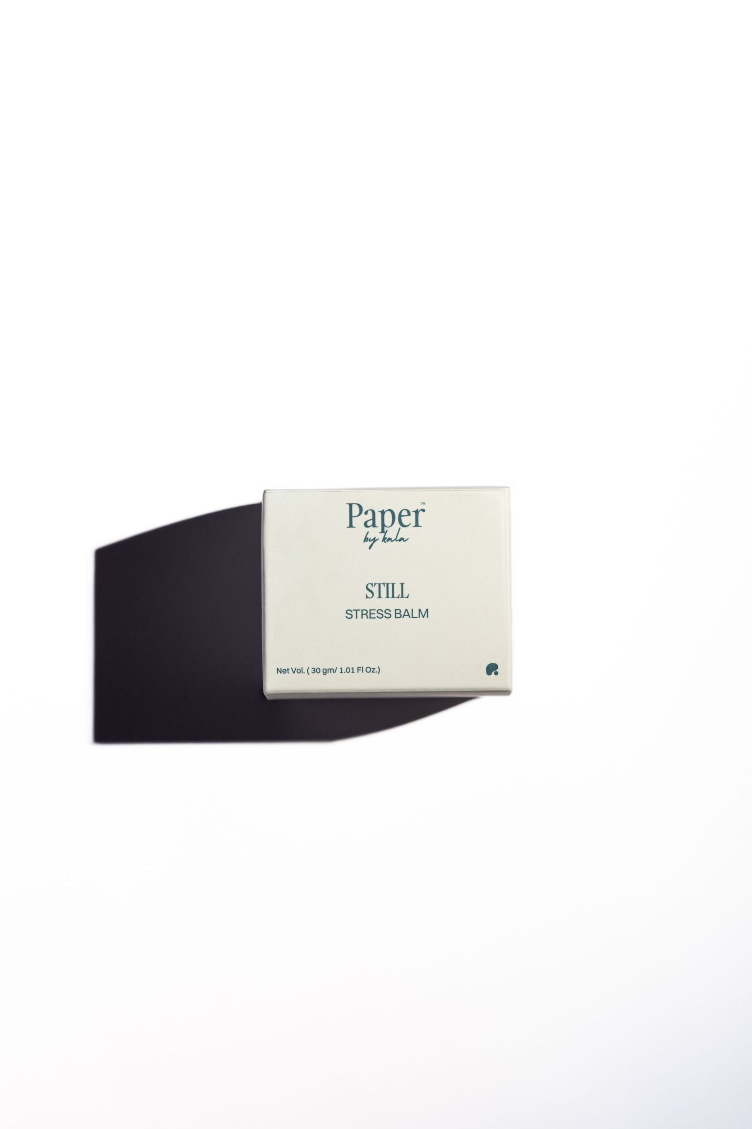 Cream-colored Paper by Lala STILL Stress Balm box with green text, casting a dark shadow on a clean white background.