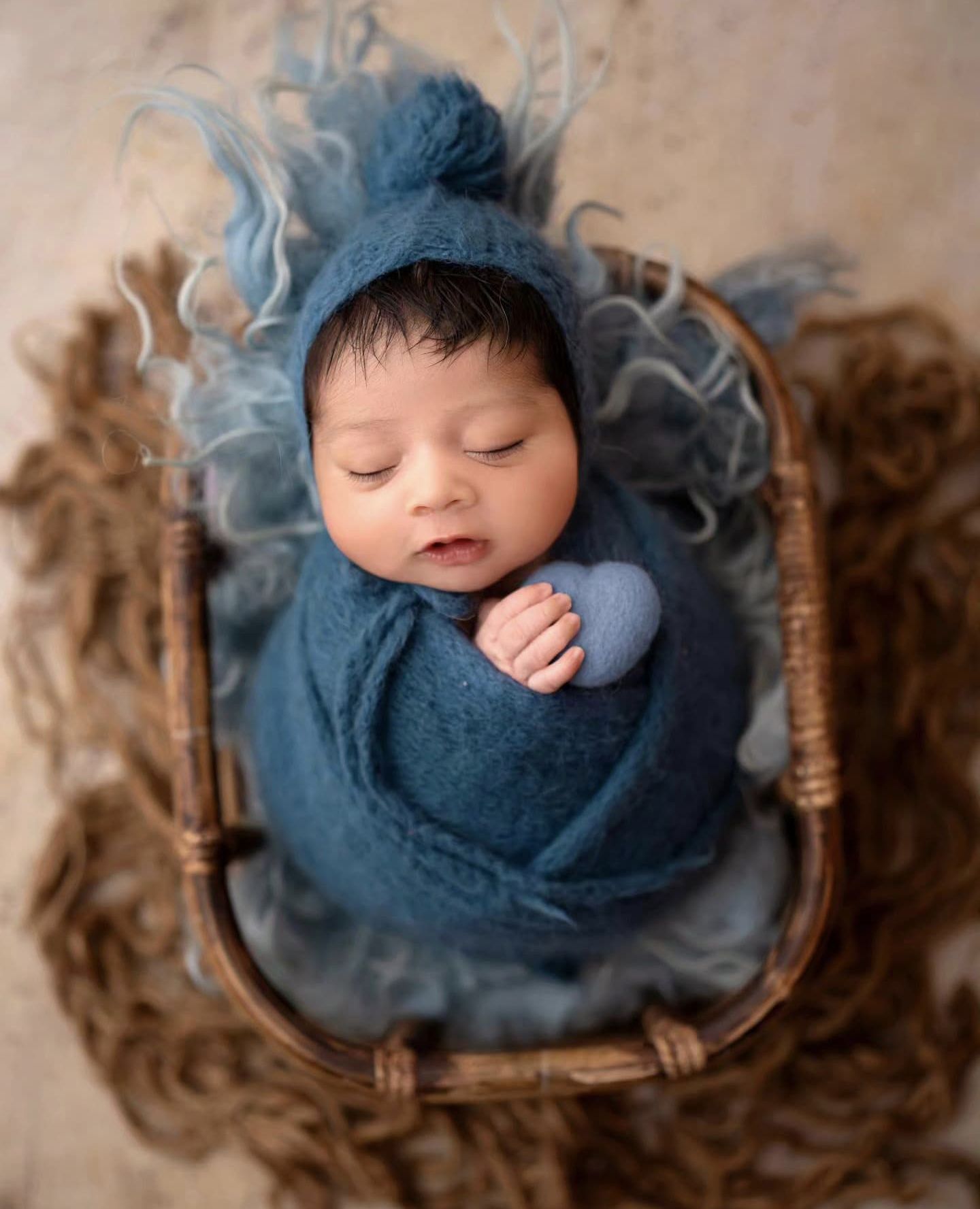 Baby in heart-shaped prop for adorable new born photoshoot – Impresio Studio
