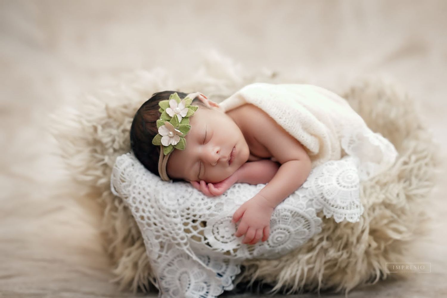 Peaceful newborn baby sleeping in a rustic basket with lace and fur, wearing a delicate floral headband.