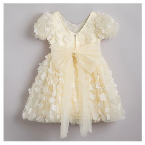 Ivory special occasion dress with butterfly appliques, puff sleeves, and large bow detail.