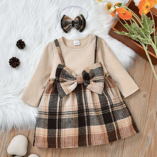 Plaid baby dress in beige and brown tones with bow detail and matching accessories.