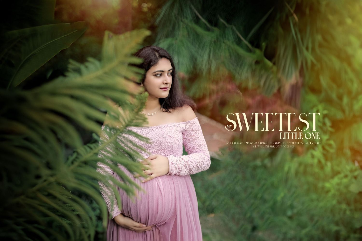 Enchanting maternity portrait in pink dress surrounded by lush greenery.