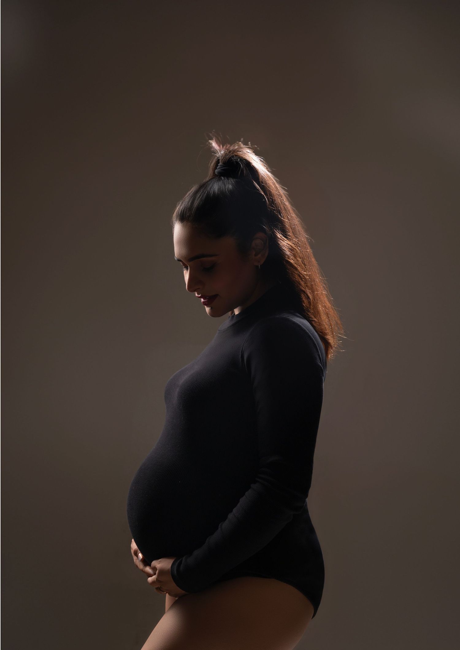 Intimate studio portraits with dramatic lighting highlighting silhouette and form.