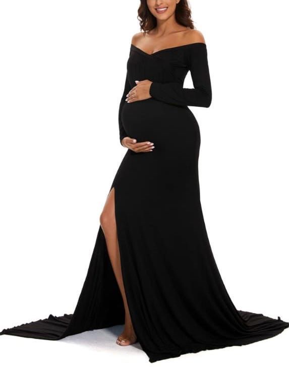 Elegant maternity photography showing a black floor-length dress against white backdrop.