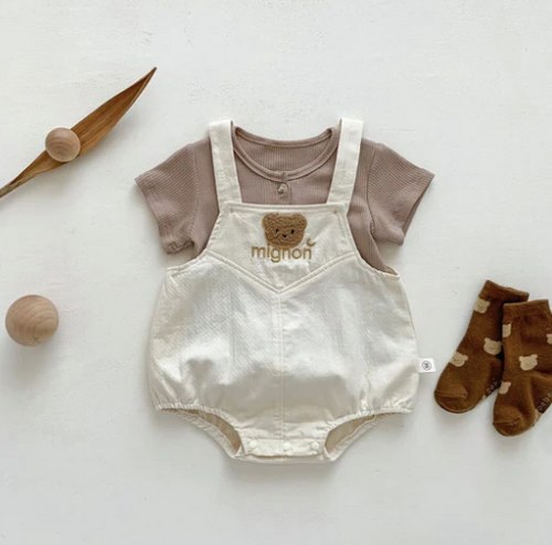 Neutral-toned baby romper with teddy bear design and matching brown socks on white background.
