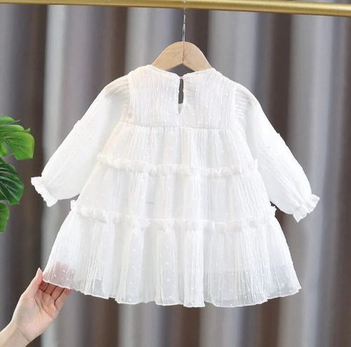 White tiered ruffle dress with long sleeves and delicate fabric for baby girls.