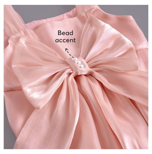 Close-up of large pink bow with pearl bead accent on baby clothing.