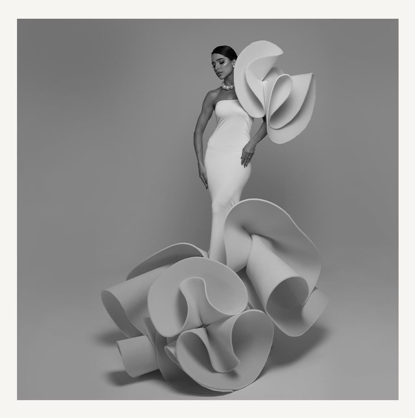 Abstract sculptural forms in gray tones creating flowing organic shapes.