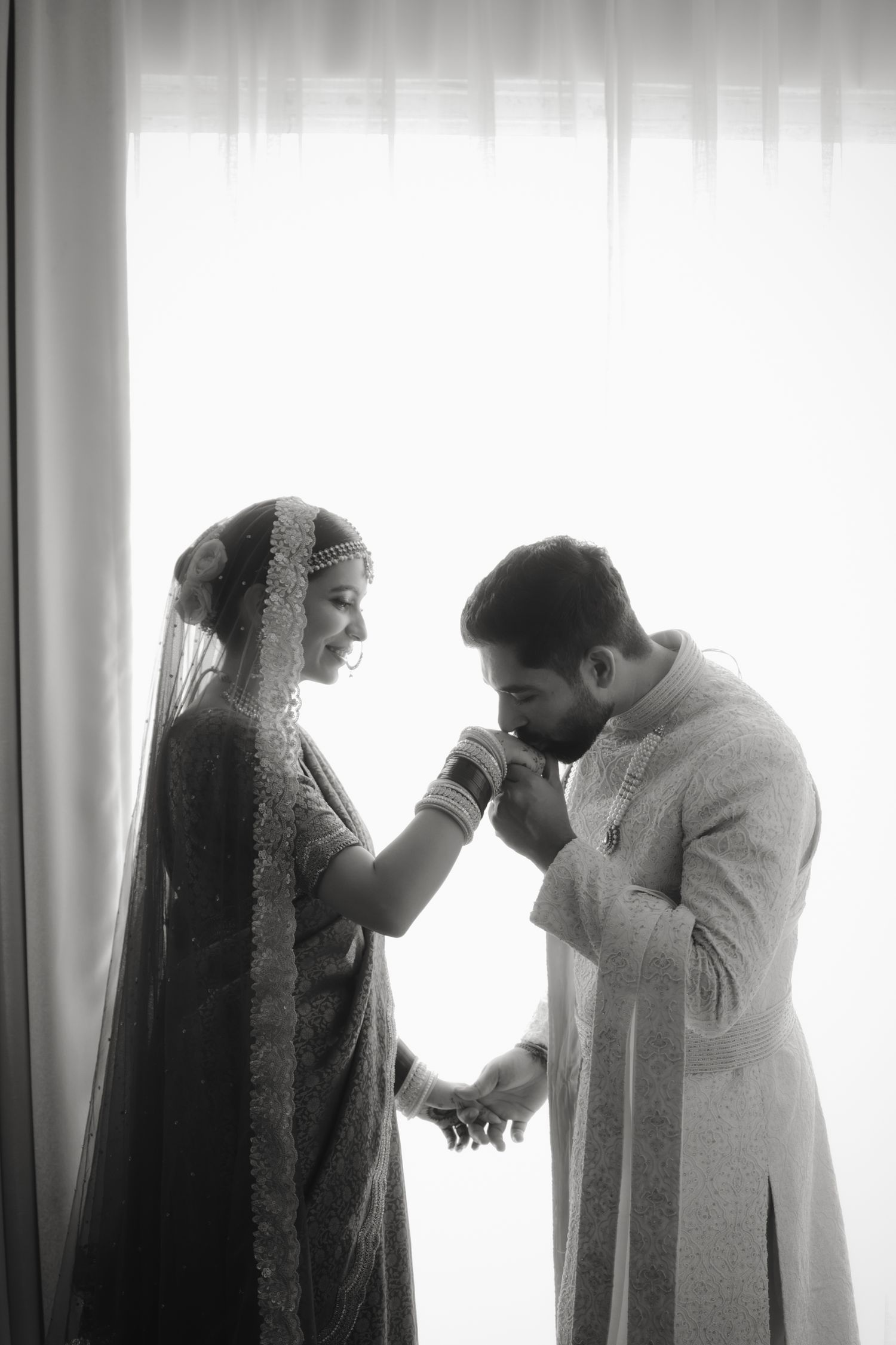 A romantic sequence of silhouettes showing a couple in an intimate moment against a bright window backdrop.
