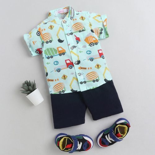 Baby boy outfit featuring mint transportation print shirt and navy shorts with coordinating shoes.