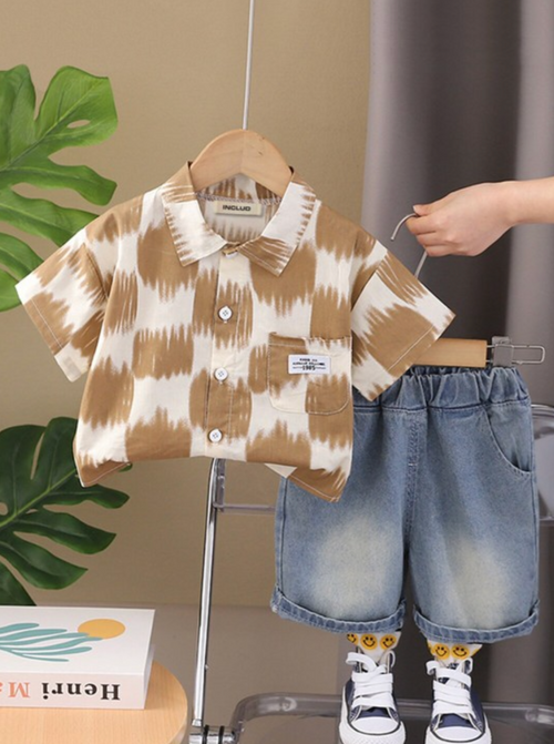 Toddler outfit with brown and white patterned shirt and denim shorts.
