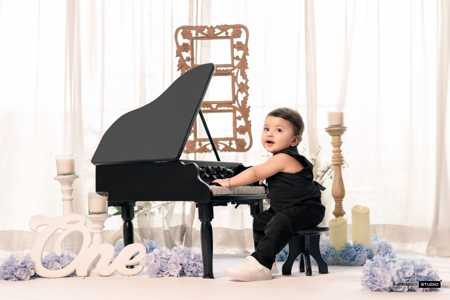 A classical musician performs at a grand piano in an elegant white room with ornate decorative details.
