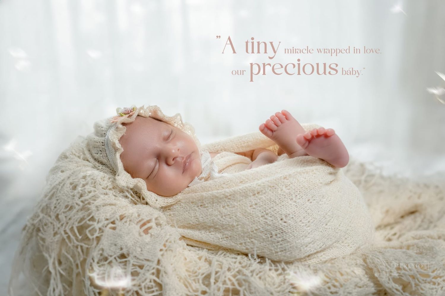 Sleeping newborn baby wrapped in cream knit blanket in a basket with soft white feathers and inspirational quote.