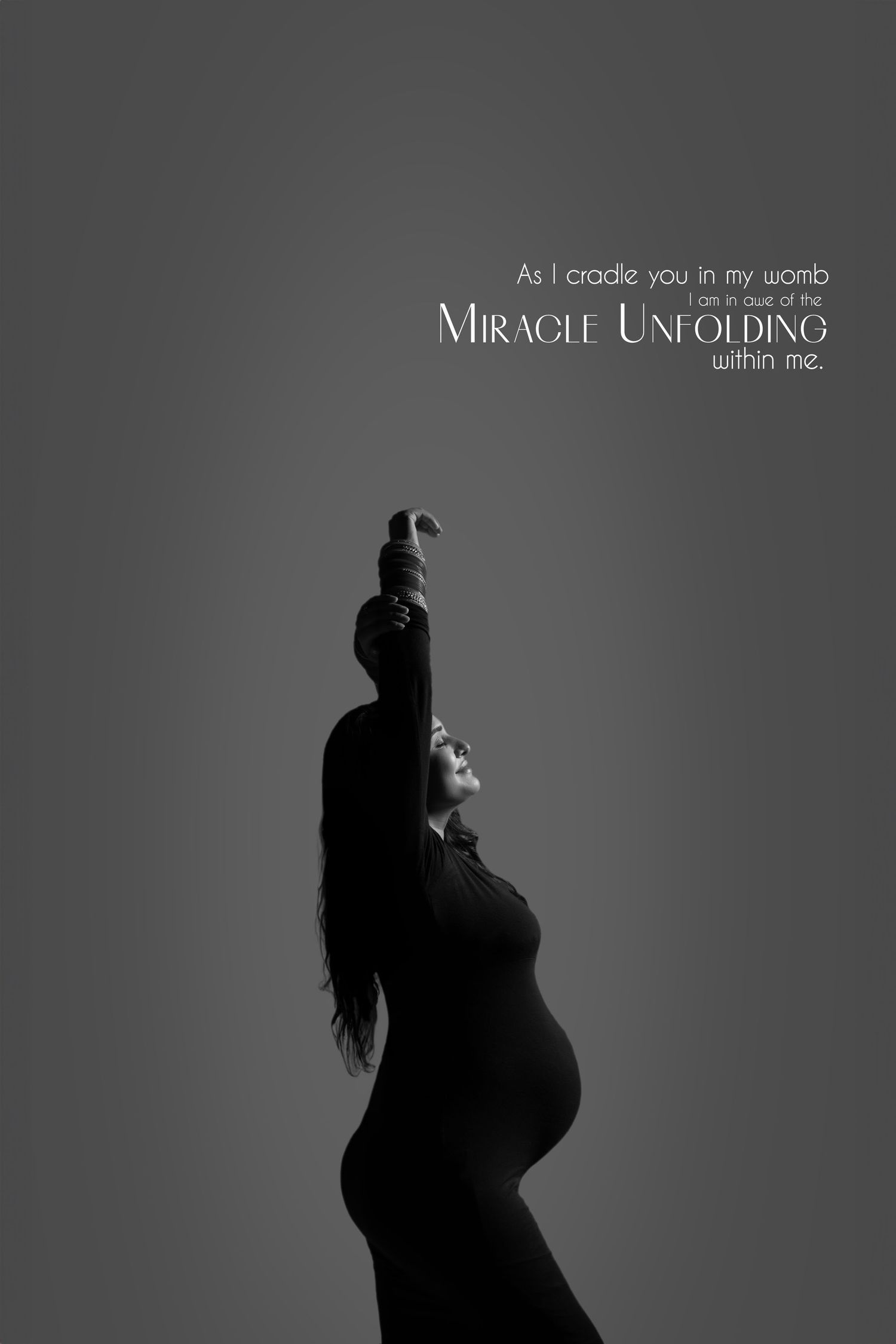 Artistic black and white maternity silhouette with text overlay 'Miracle Unfolding' against gray background.