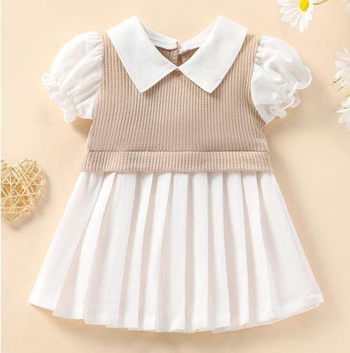 Beige and white pleated baby dress with peter pan collar and puff sleeves.