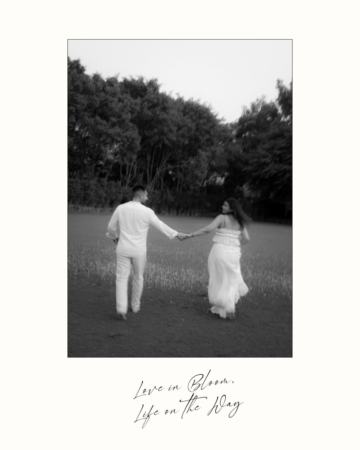 Black and white photo of a couple holding hands in a field, with cursive text reading Love in Bloom, Life on the Way.