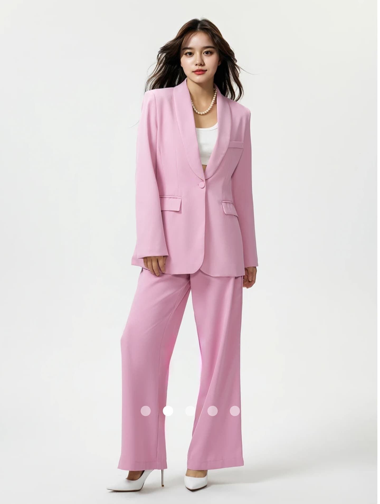 Professional studio photos featuring soft pink pantsuit outfit against white background.
