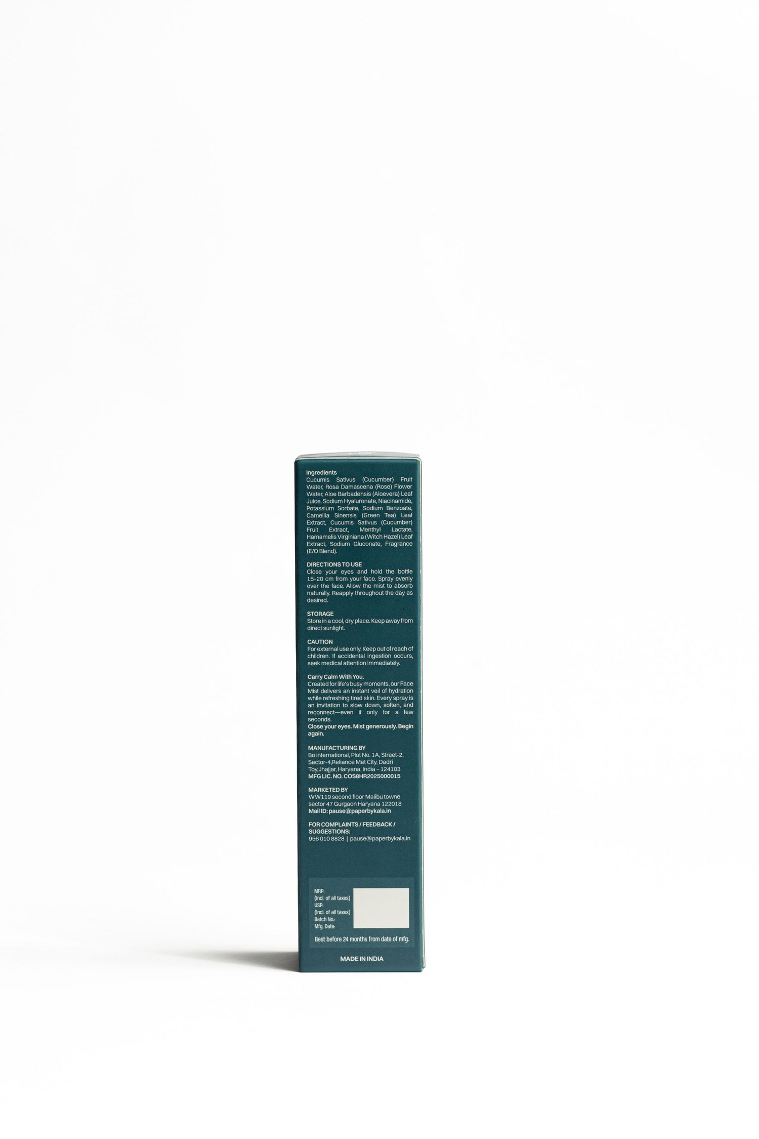 Side view of a tall dark teal skincare product box with small white ingredient and usage text printed on a clean white background.