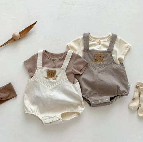 Trendy toddler outfit set featuring white lace crop top and denim shorts with bow detail.