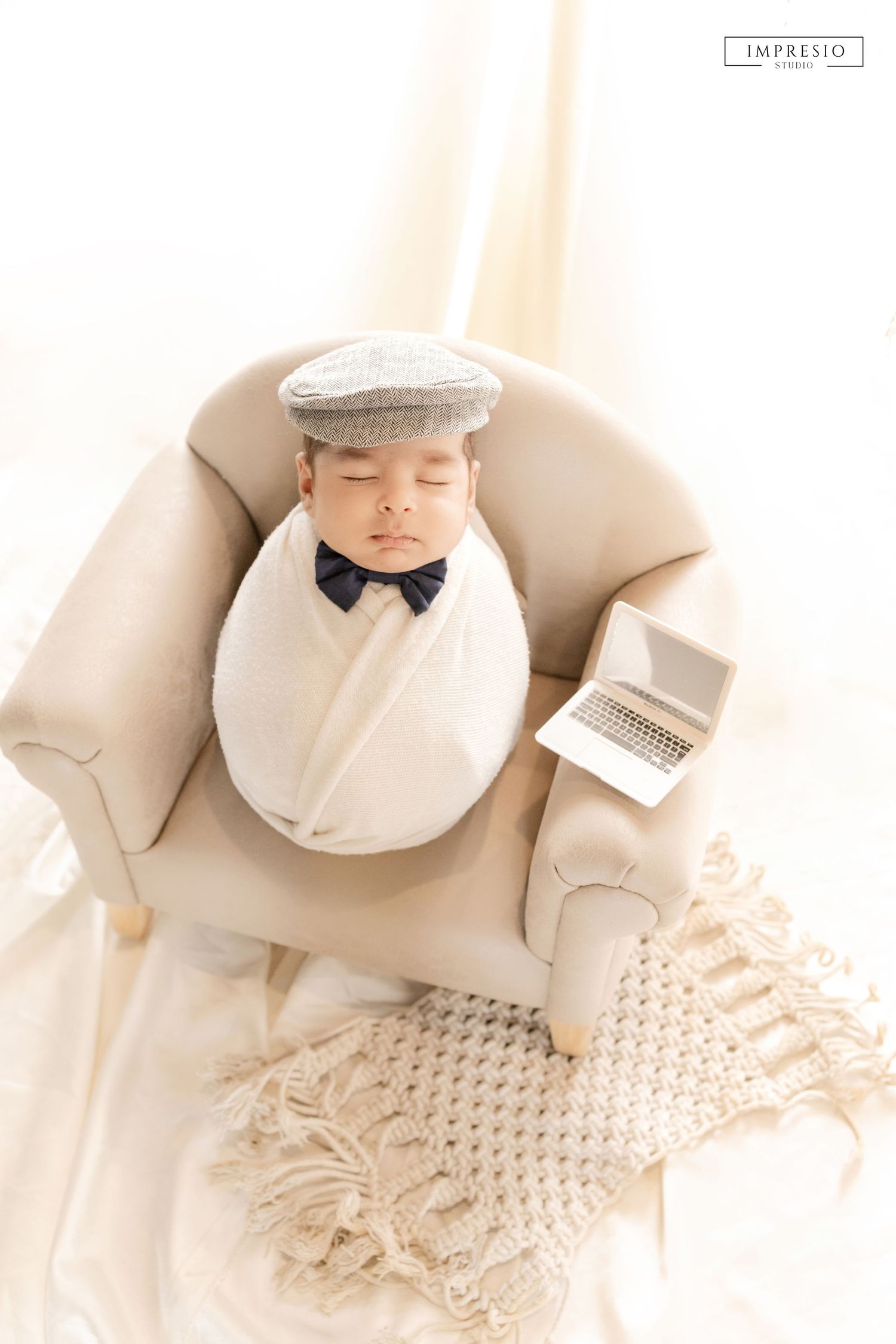 Baby lying on soft fur blanket during new born shoot – Impresio Studio