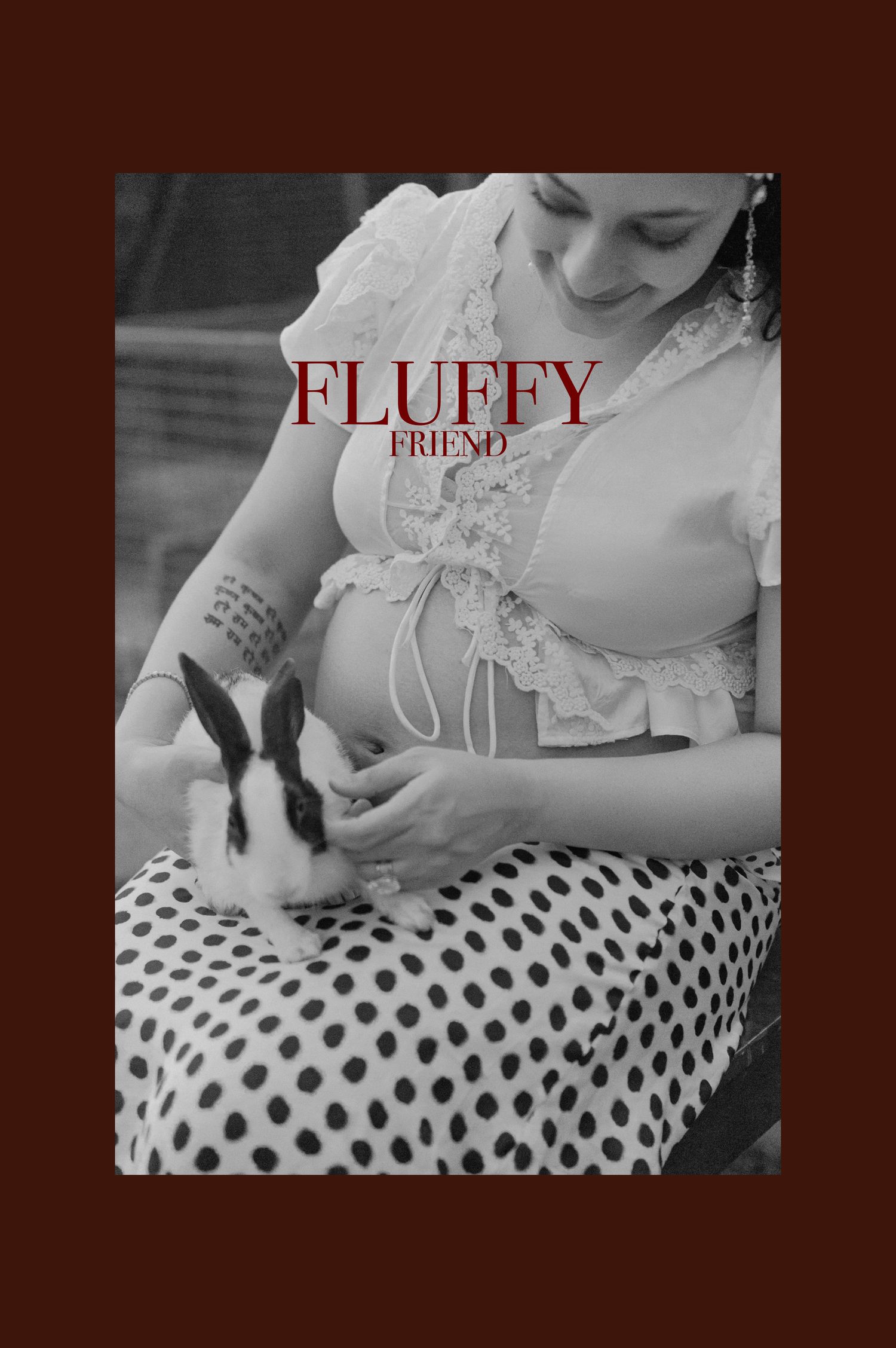 Woman in lace top and polka dot skirt gently holding a black and white bunny rabbit.