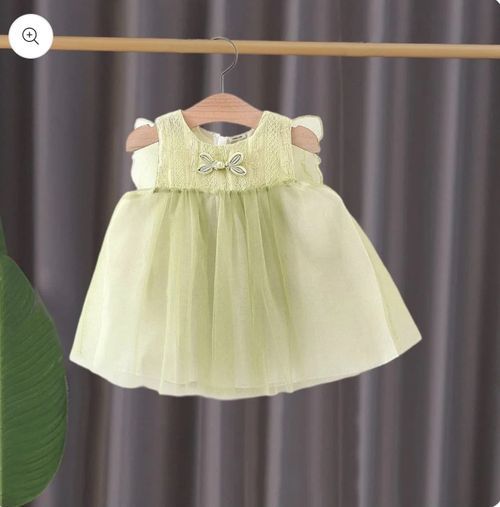 Delicate mint green baby dress with bow detail.