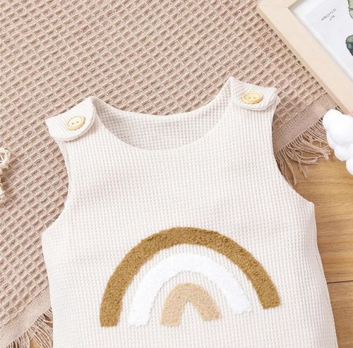 Clothing image showing a series of beige bodysuits with teddy bear ear designs laid out in a row.