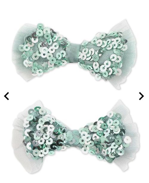 Mint green sequined hair bows arranged in various display positions.
