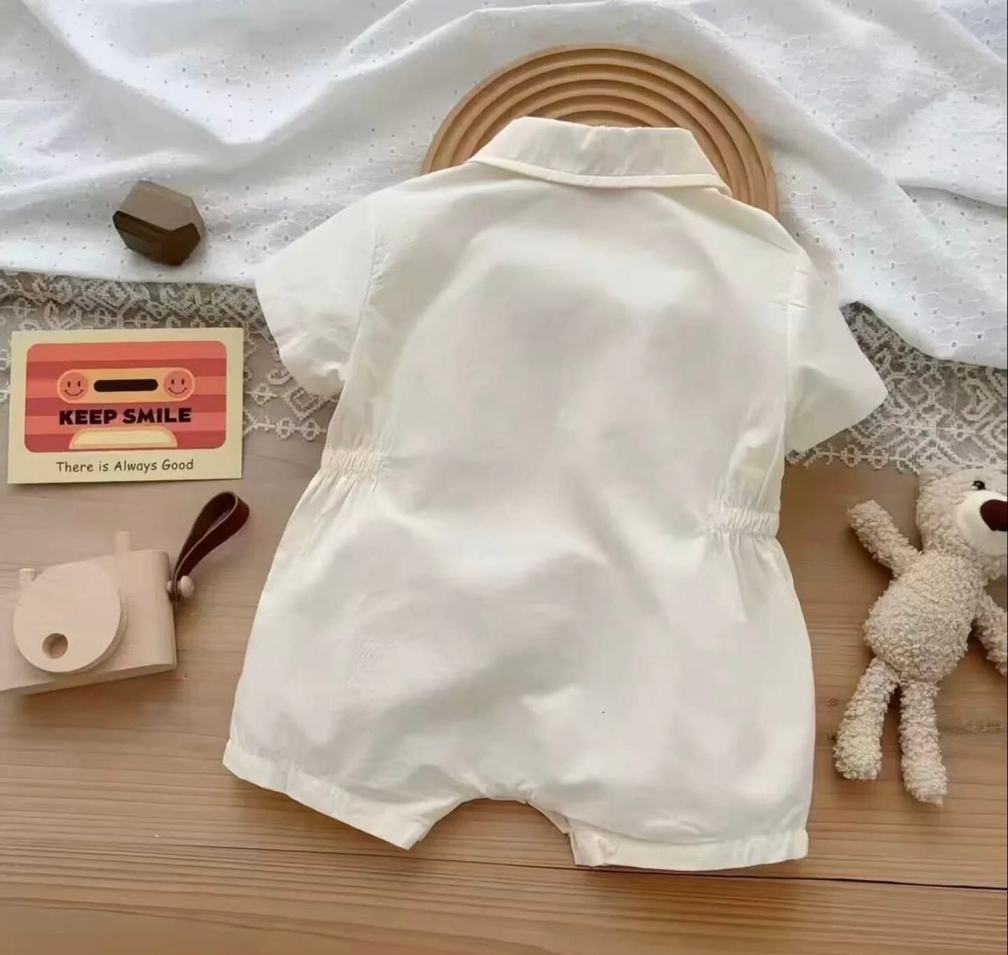 A visual sequence showing a white pillowcase being folded in multiple steps on a wooden surface next to a plush toy.
