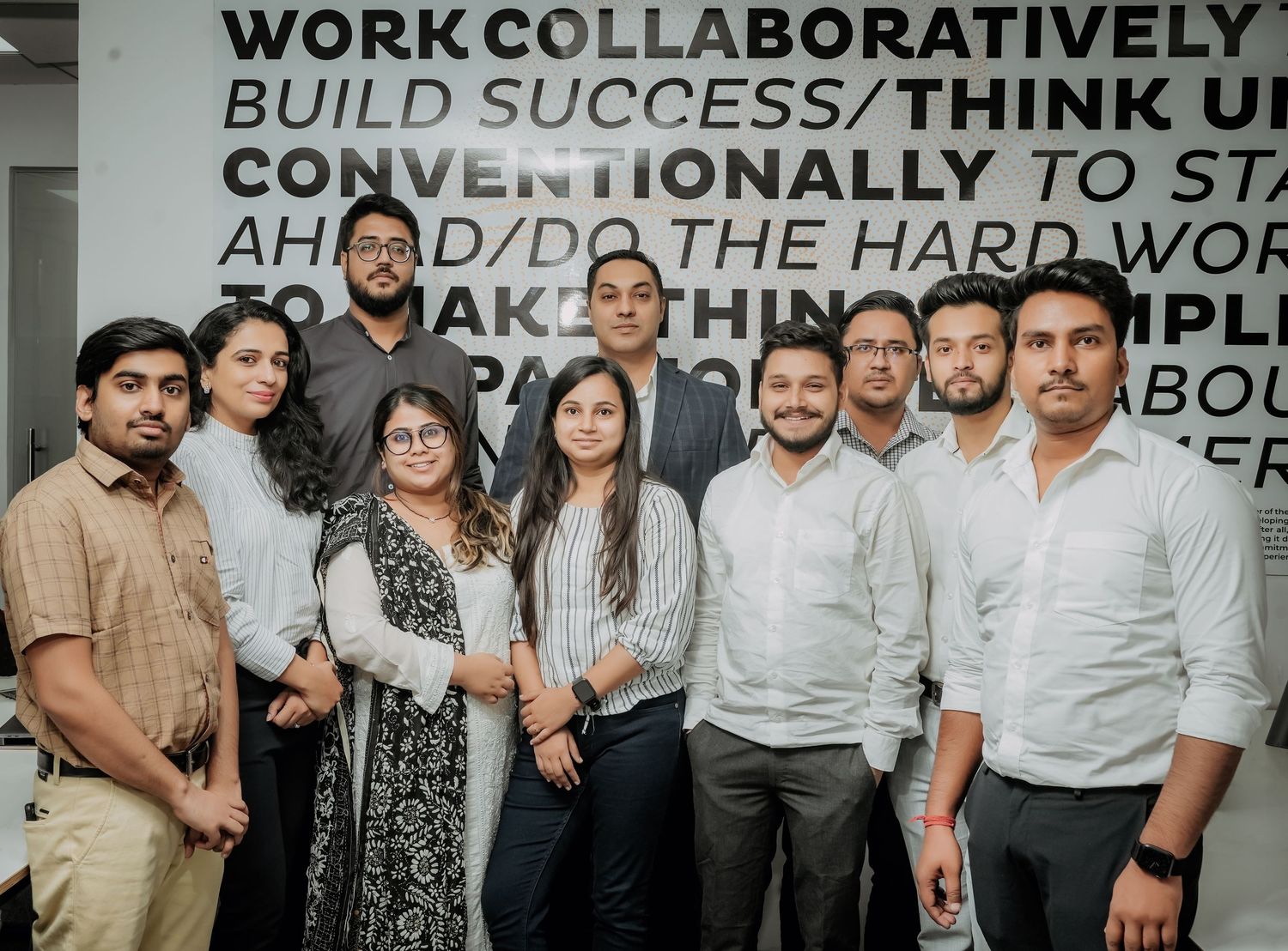 A collage of black and white office photos showing people working together in collaborative business settings.