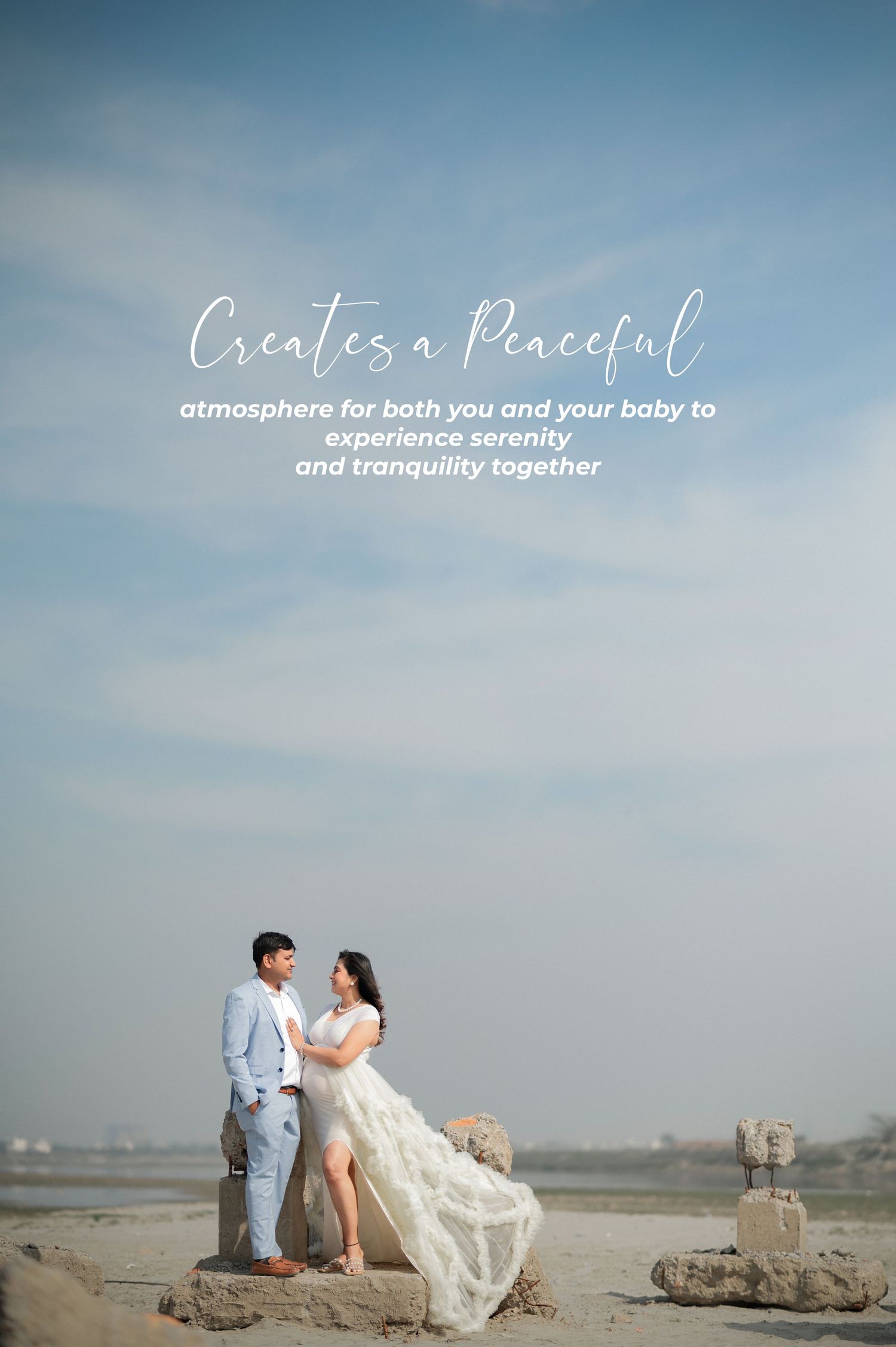 Coastal maternity photography on rocky beach with soft blue sky and romantic text overlay.