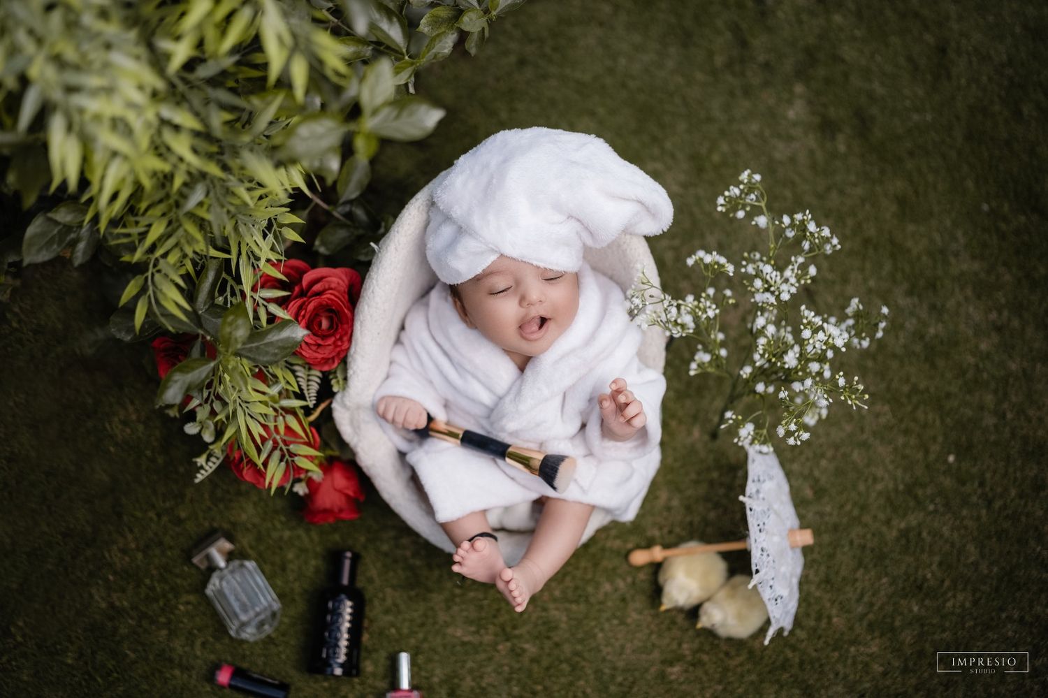 Baby girl wrapped in pink swaddle for new born photoshoot – Impresio Studio