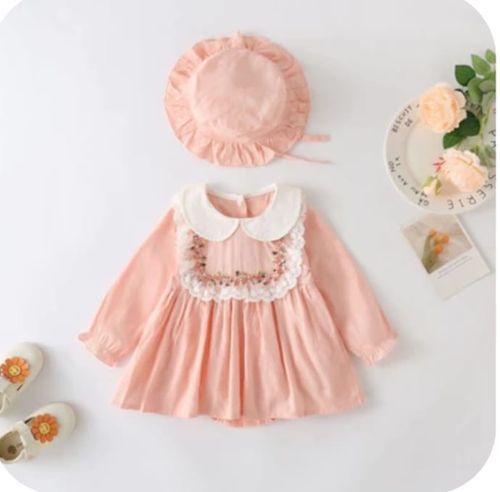 Pink baby dress with white collar and floral embroidery paired with matching bonnet.