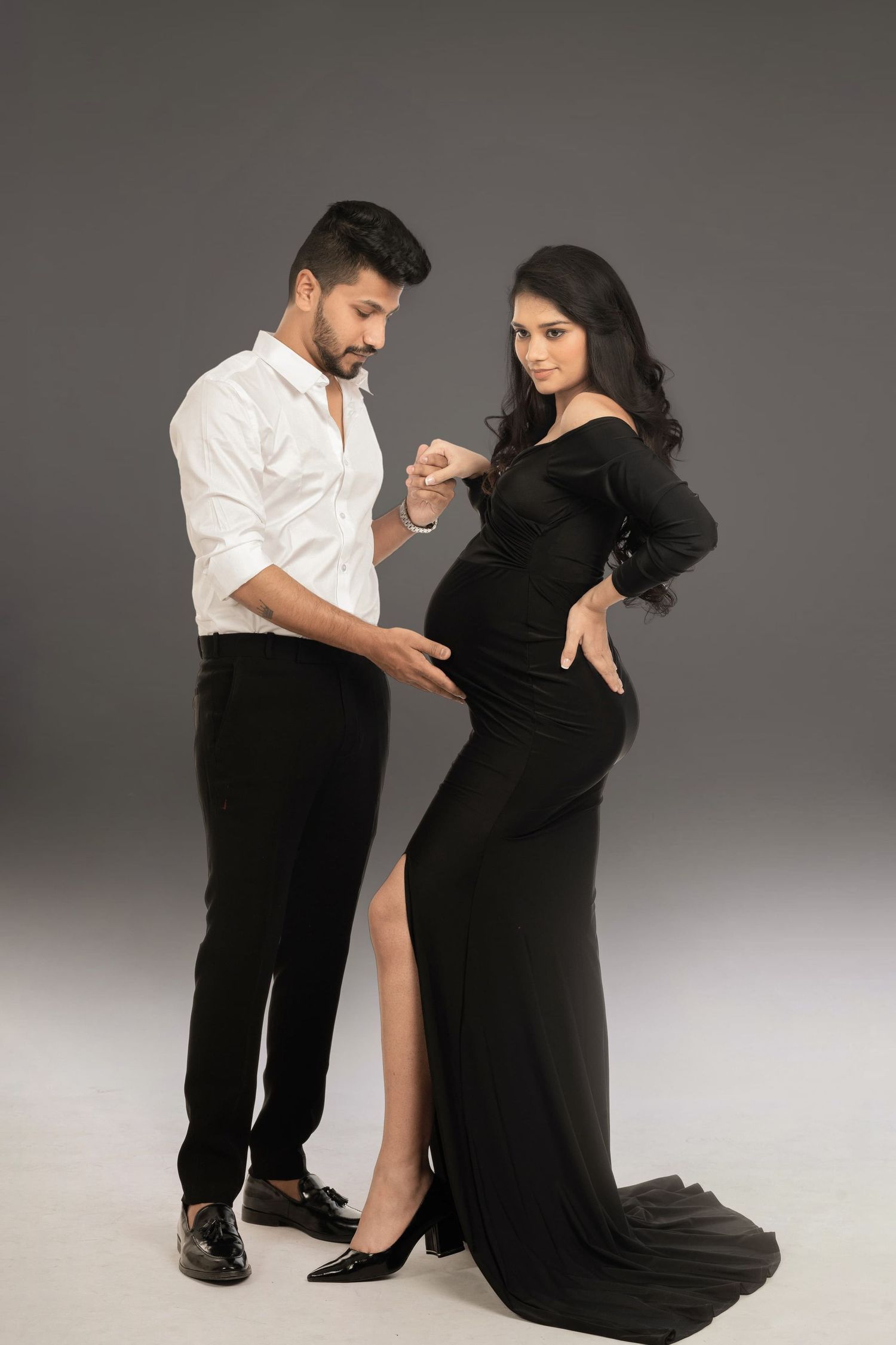 Dynamic couple's maternity photoshoot with dance-inspired poses.